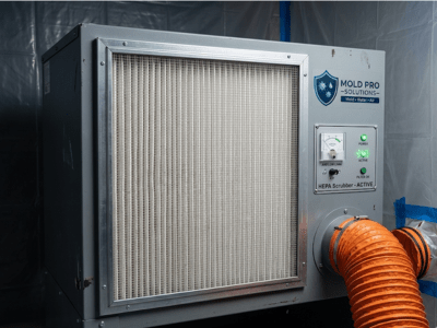 Industrial HEPA air scrubber running during mold remediation project