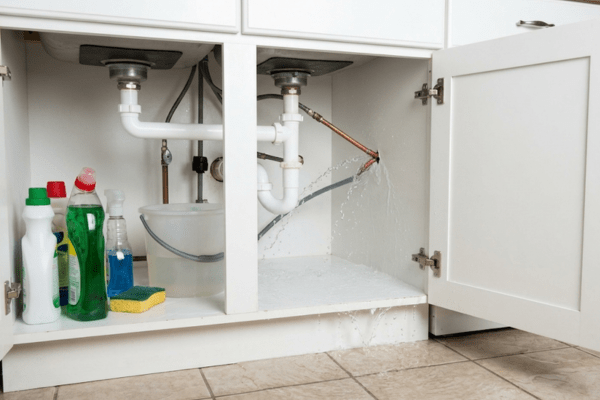 Clean water damage from burst pipe flooding residential kitchen floor