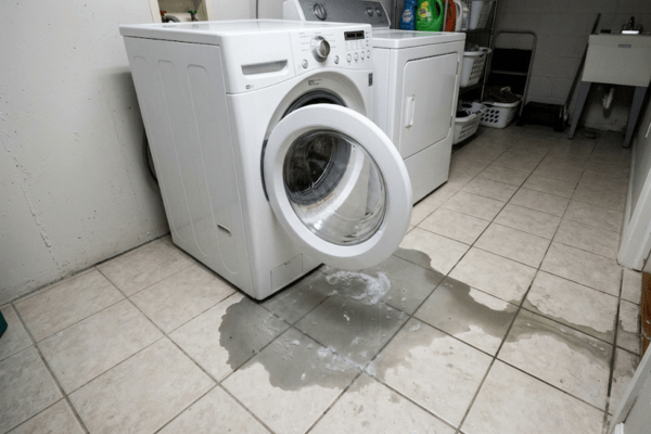 Gray water damage from washing machine overflow on residential floor