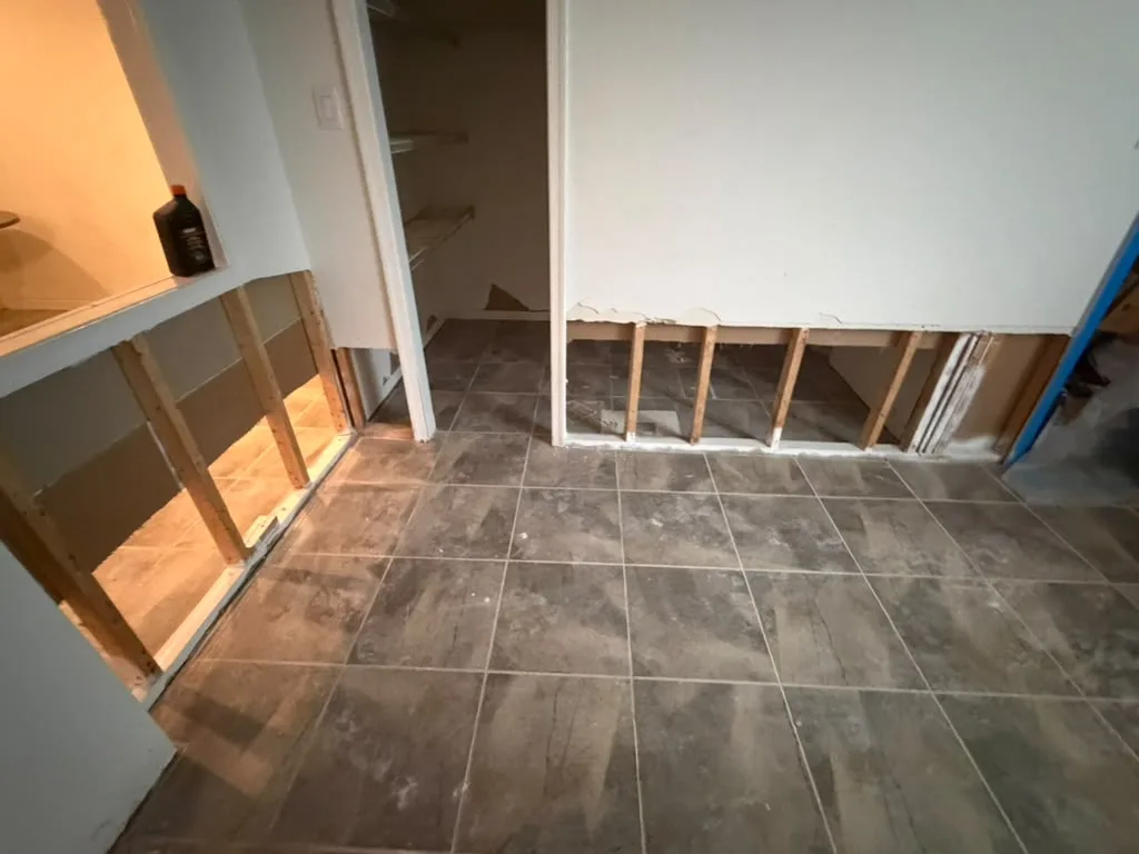 Finished basement after mold remediation with lower drywall removed and clean exposed studs - Potomac MD